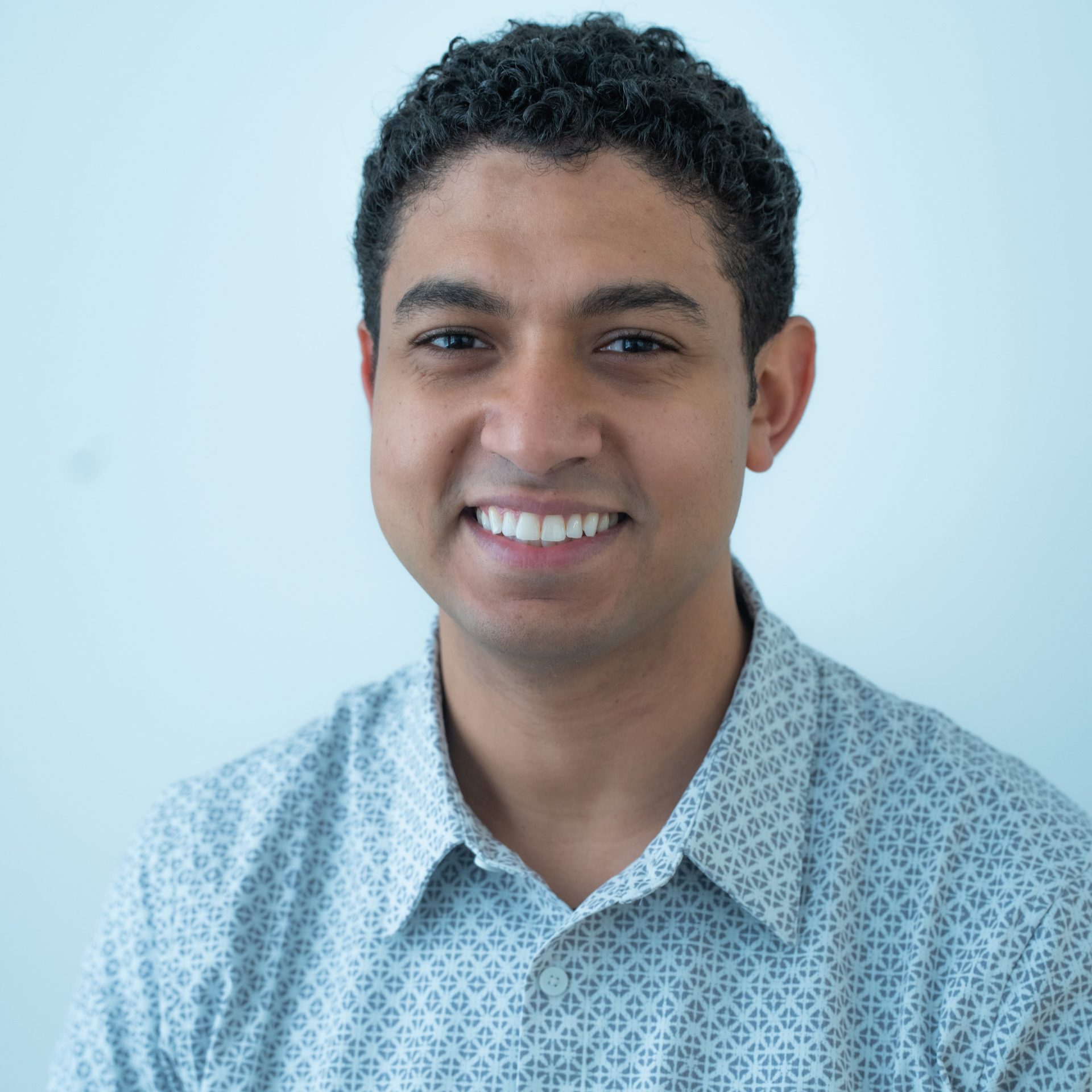 Portrait of Dr. Andrew Awad smiling in a light patterned shirt
